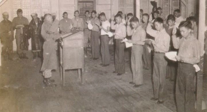 New recruits being sworn in. photo taken estimated months after July with wet raincoats