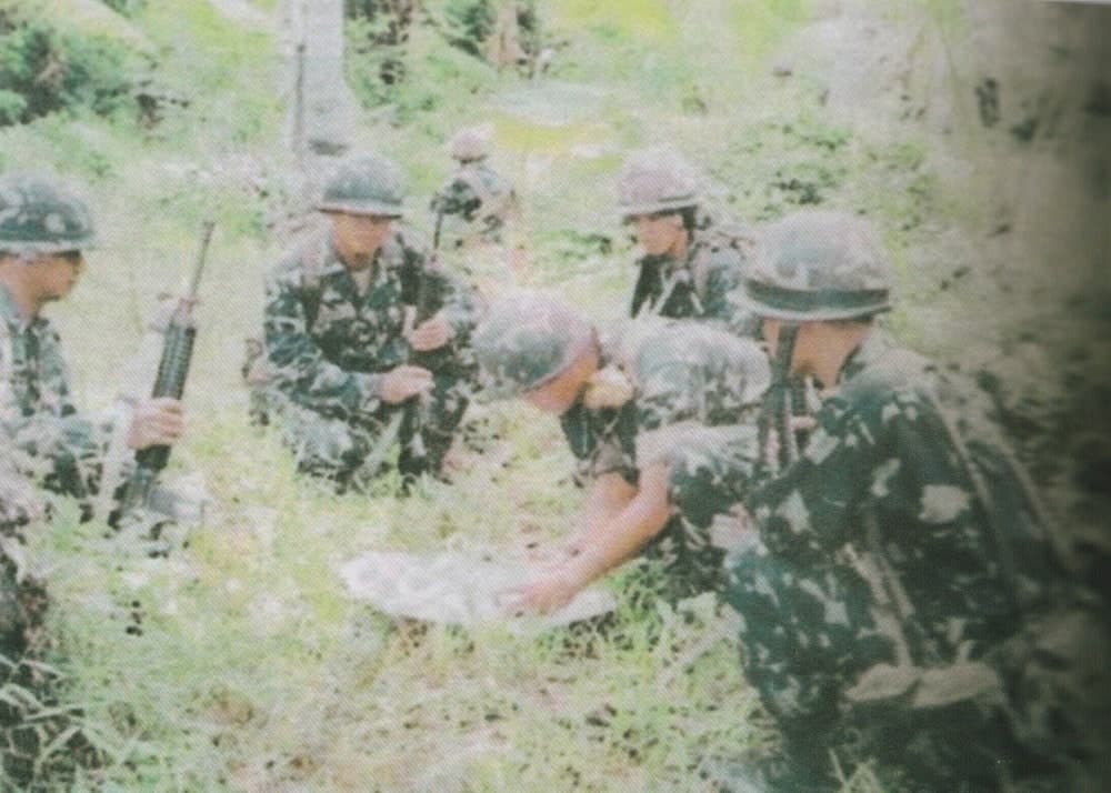 A Marine squad orienting their map during on of the combat operations against the MI