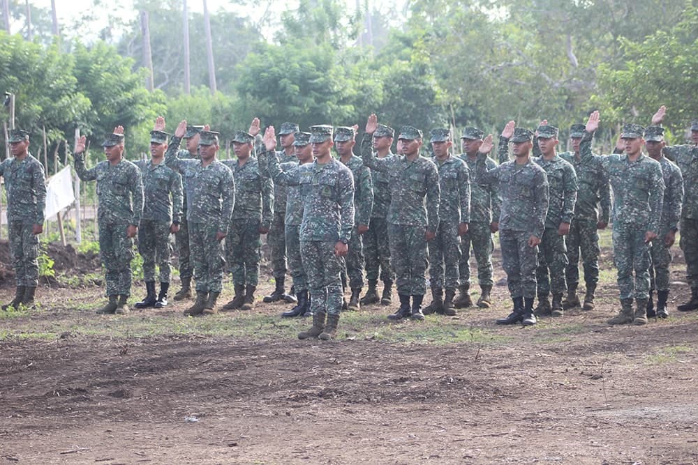 Marine raising right hand during formation